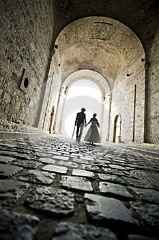 An elegant couple walk in the tunnel