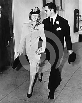 Elegant couple walking together hand in hand