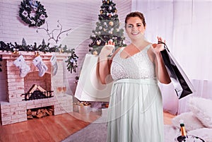 Elegant, curvy woman with shopping bags