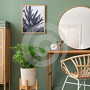 Elegant details of modern interior design with wooden sideboard, bed, mirror, painting and stylish personal accessories. Green