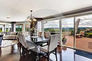 Elegant dining area with walkout deck in luxury house photo