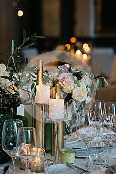 Elegant, dining table adorned with white floral arrangements, prefect for a wedding