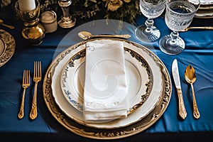 Elegant dinner table setting arrangement in English country style as flatlay tablescape, folded napkin on a serving