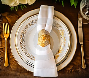 Elegant dinner table setting arrangement in English country style as flatlay tablescape, folded napkin on a serving plate,