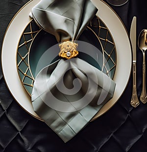 Elegant dinner table setting arrangement in English country style as flatlay tablescape, folded napkin on a serving plate,