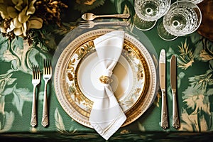 Elegant dinner table setting arrangement in English country style as flatlay tablescape, folded napkin on a serving plate,