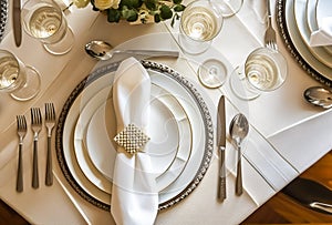 Elegant dinner table setting arrangement in English country style as flatlay tablescape, folded napkin on a serving plate,