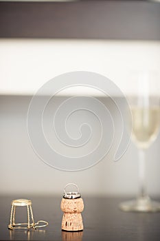 An elegant display of a wedding ring on a champagne with a