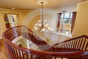 Elegant double staircase with a chandelier.