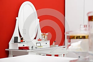 Elegant dressing room interior with makeup table near wall