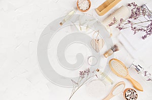 Elegant eco accessories for aromatherapy, massage with cosmetic products, perfume, essential oil, dry herbs on soft light white.