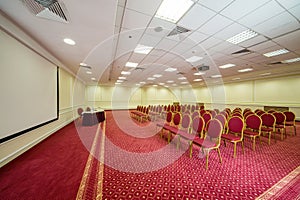 Elegant empty conference hall with a red carpet on