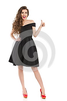 Elegant Excited Woman In Black Dress Gives Thumb Up