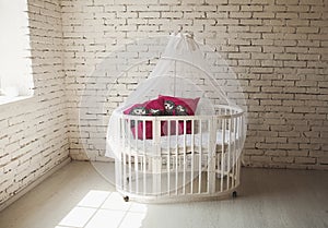 Elegant expensive bed for newborn baby. Luxury decorations of apartments