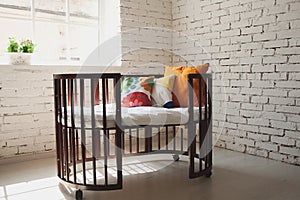 Elegant expensive bed for newborn baby. Luxury decorations of apartments