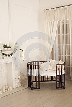 Elegant expensive bed for newborn baby. Luxury decorations of apartments