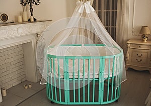 Elegant expensive bed for newborn baby. Luxury decorations of apartments