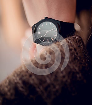 Elegant fashion black watch on woman hand