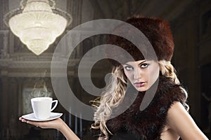 Elegant fashion lady with cup of tea photo