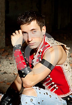 Elegant fashion man model wear red shirt and hat near bare walls