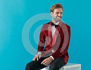 Elegant fashion man smiling and wearing red velvet tuxedo