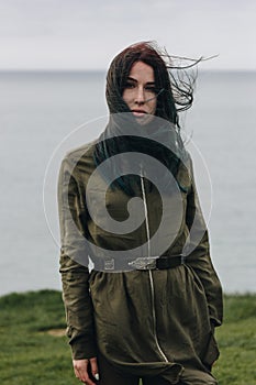 elegant fashionable girl posing on cliff near the sea Etretat