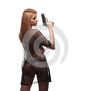 Elegant fashionable woman with a gun in hands