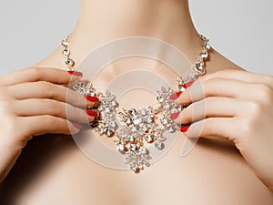 Elegant fashionable woman with jewelry. Beautiful woman with diamond necklace. Young beauty model with manicured nails