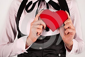 Elegant female holding red heart in hands