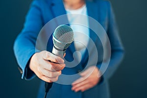 Elegant female journalist conducting business interview or press