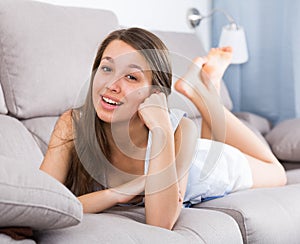 Elegant female is posing on sofa