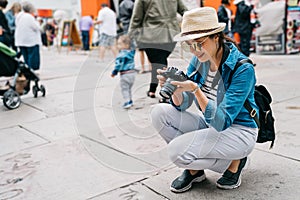 An elegant female traveler crouch on the street