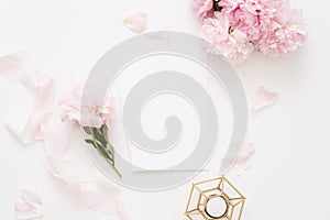 Elegant feminine wedding or birthday flat lay composition with pink peonies