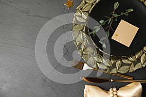 Elegant festive table setting with blank card on grey background, flat lay. Space for text