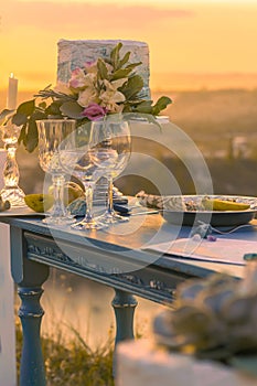 Elegant festive table setting with colorful flowers, cutlery, candles
