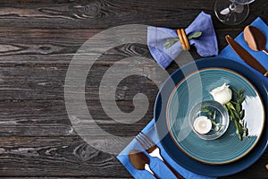 Elegant festive table setting on wooden background, flat lay. Space for text