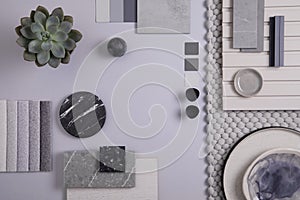 Elegant flat lay composition in grey and black colour palette with textile and paint samples, lamella panels and tiles. photo