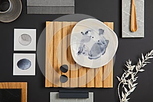 Elegant flat lay composition of interior designer moodboard with textile and paint samples, lamella panel and tiles. Black, beige.