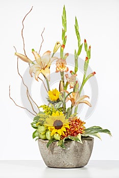 Elegant flower arrangement in beautiful vase isolated in a bright white studio