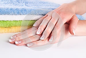 Elegant French Nails Manicure on Colorful Towels - Femininity and Beauty Concept - Close-Up Shot