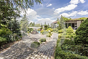 Elegant garden with the paved path photo