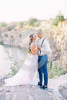 Elegant gentle stylish groom and bride near river or lake