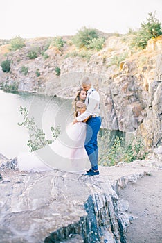 Elegant gentle stylish groom and bride near river or lake