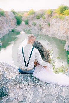 Elegant gentle stylish groom and bride near river or lake