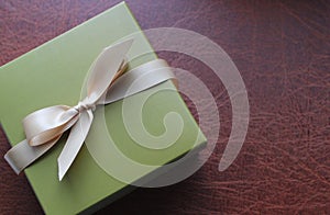 Elegant Gift Box On A Leather Surface Top View Concept Photo For Greeting Cards Or Holiday Backgrounds