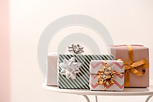Elegant gift boxes on table against color background