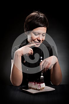 Elegant girl eating a chocolate cake