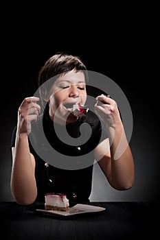 Elegant girl eating a chocolate cake