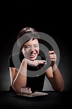 Elegant girl eating a chocolate cake