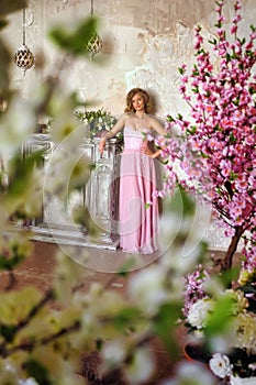 Elegant girl in a pink long evening dress